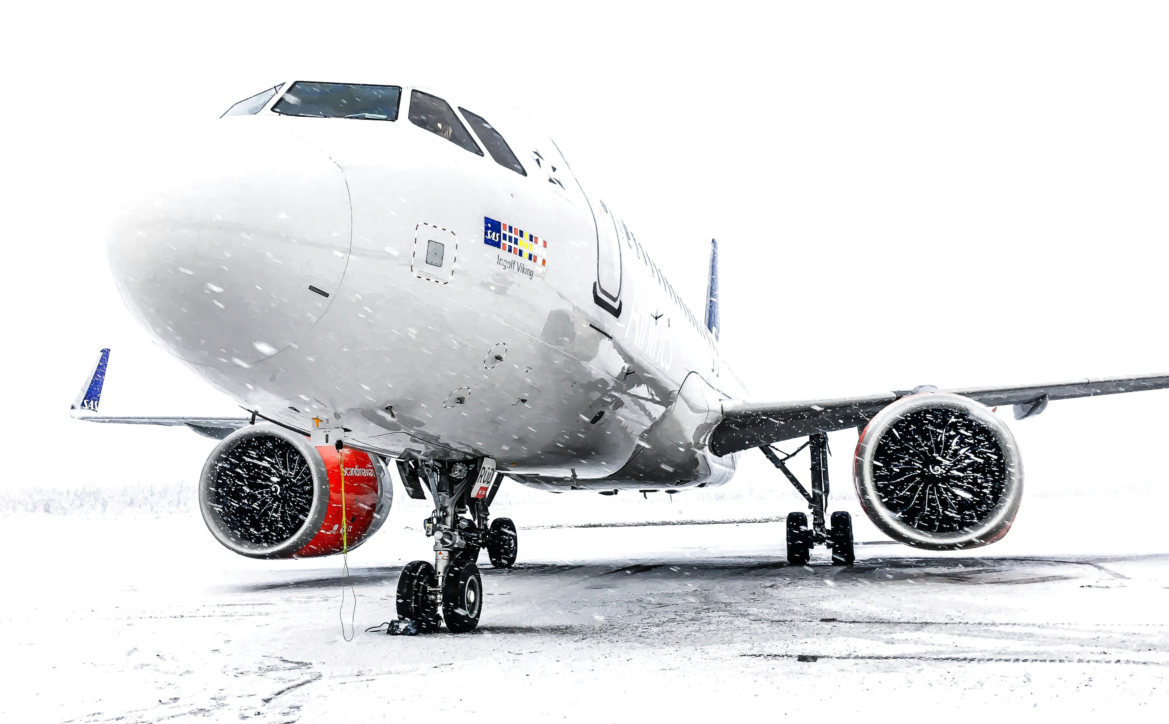 A airplane waiting to take off during a snowstorm
