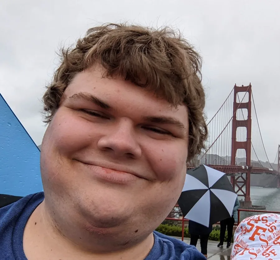 Chance Callahan smiling in front of the Golden Gate Bridge on a foggy day